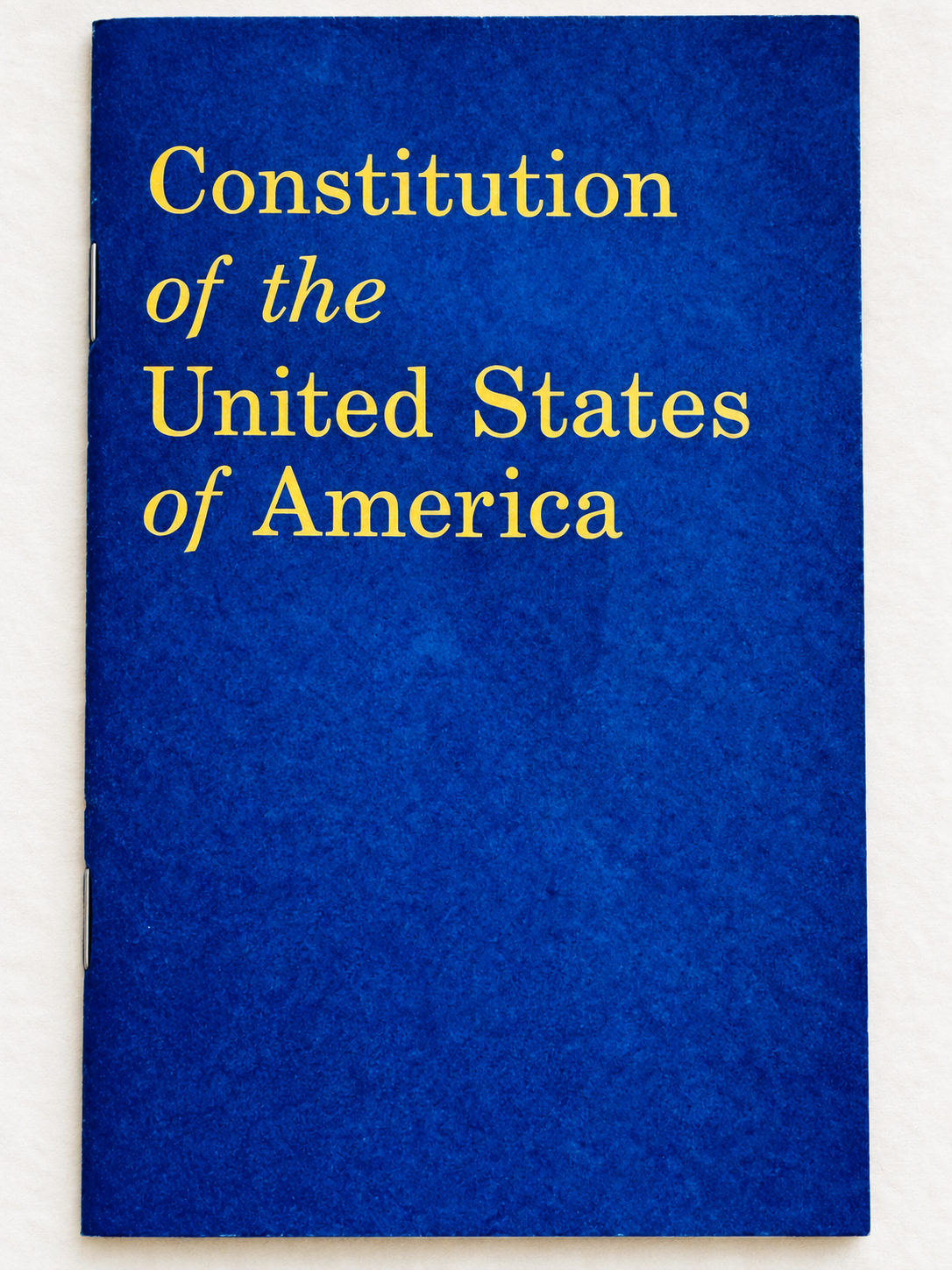 Blue Constitution of the United States of America booklet with gold lettering.